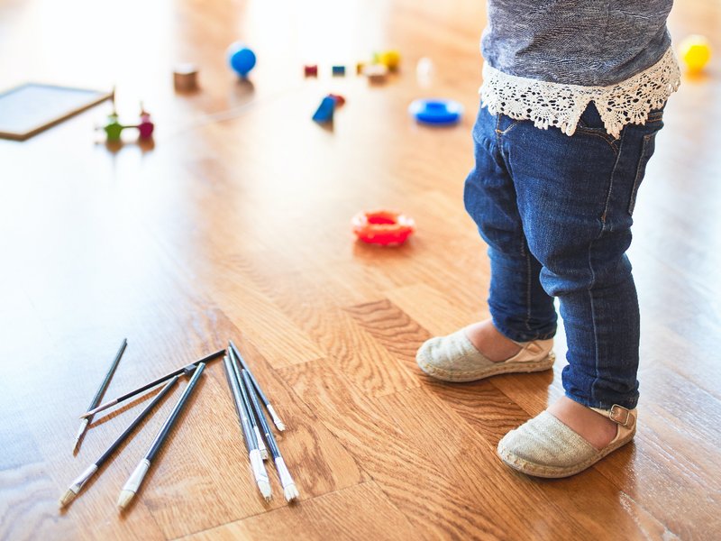 kid playing and making mess mess on hardwood floor