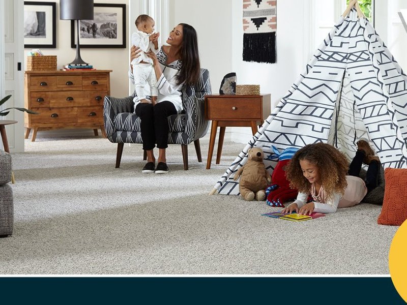 family playing in living area on carpet - Americarpets of Layton, UT